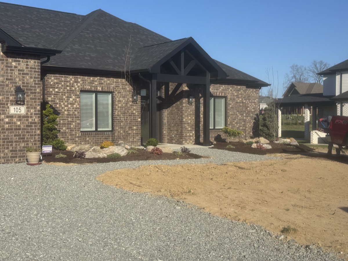 Brick home with restored hardscape and walkway